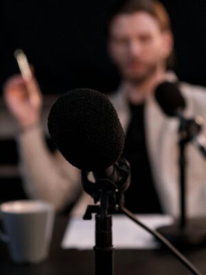 Close-up of a microphone with a blurred background, ideal for podcast themes.
